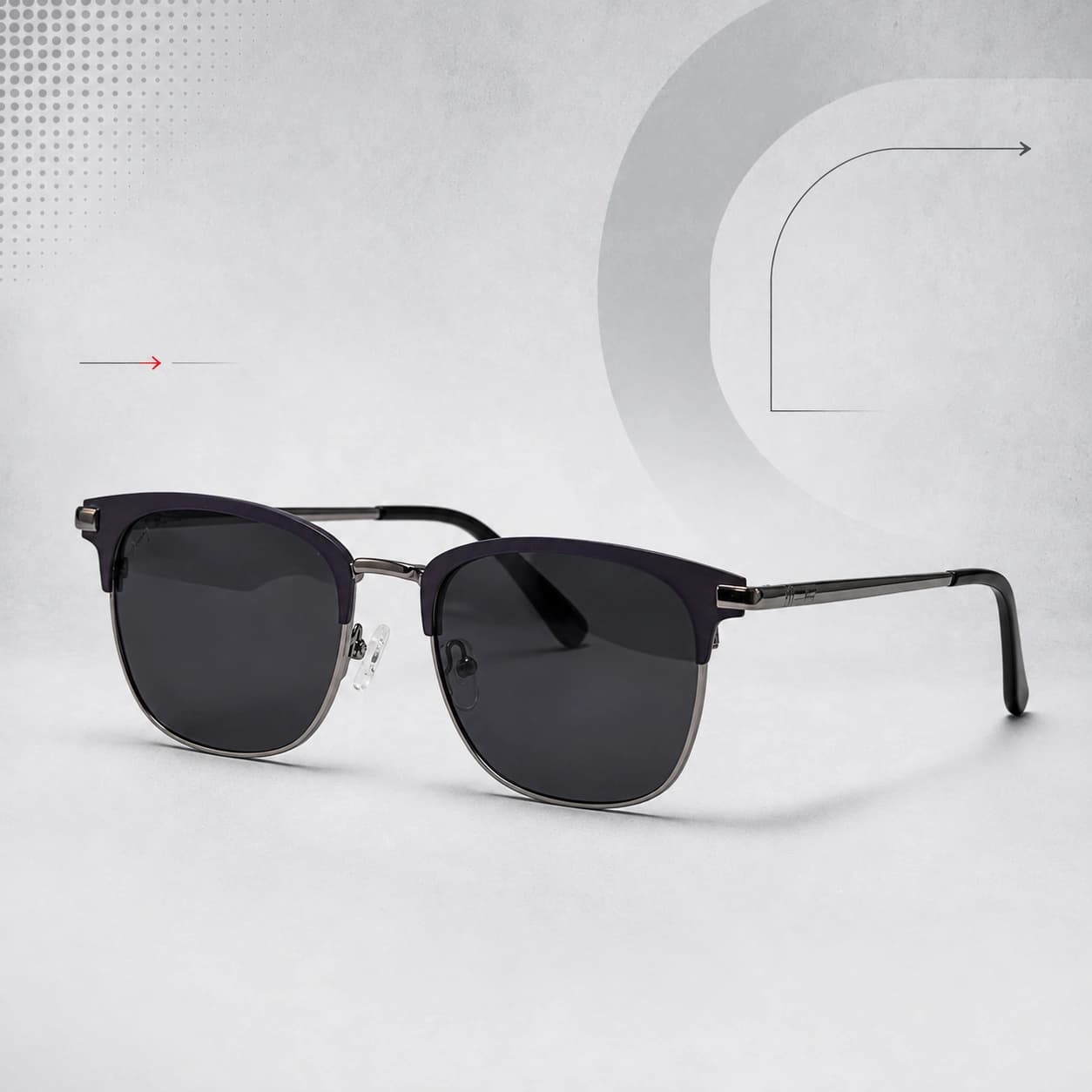 Black and gold browline sunglasses on a pale grey graphic background