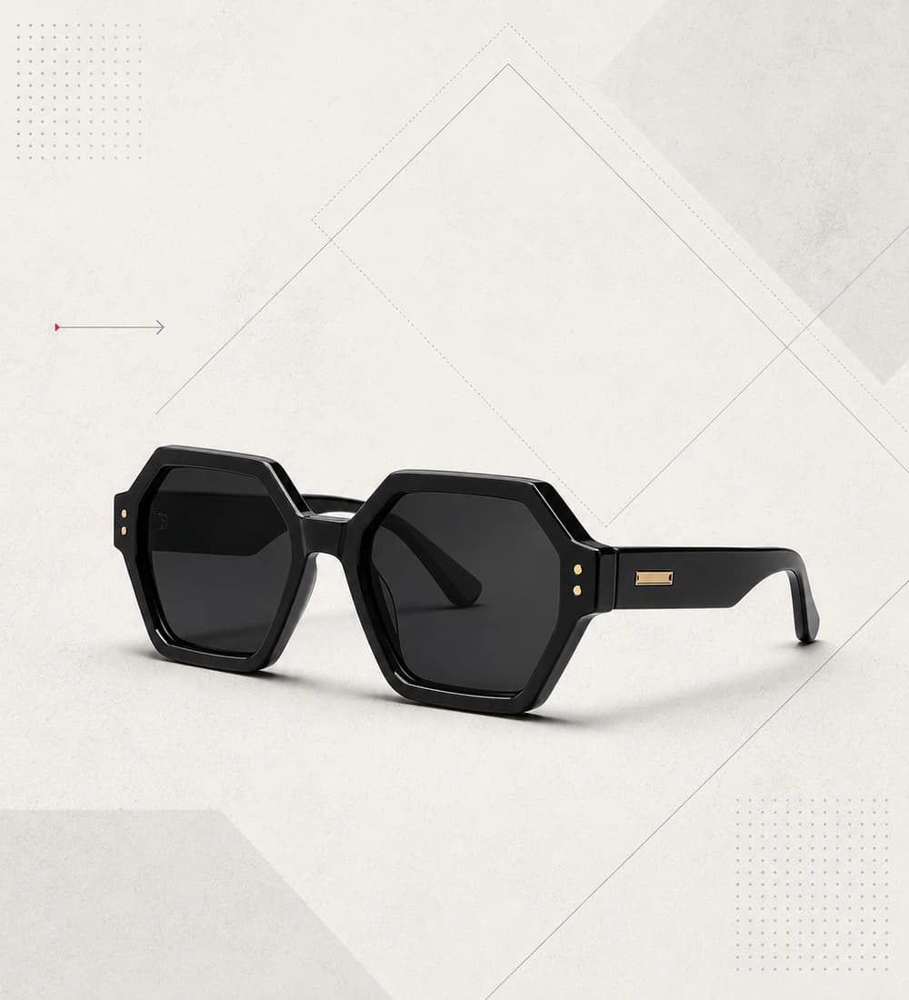 Black faceted geometric sunglasses on a warm angular graphic background